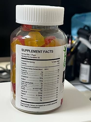 Bottle of gummy supplements with nutrition facts label.