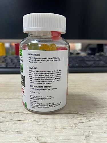 A bottle of gummy vitamins with a label listing ingredients and warnings.