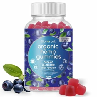 Bottle of organic hemp gummies with blueberries and gummy candies.